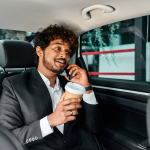 curly-haired-businessman-will-discuss-conference-car-min.jpg